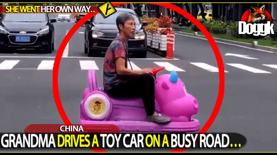 WOMAN DRIVES A TOY CAR ON A BUSY ROAD.. (CHINA)