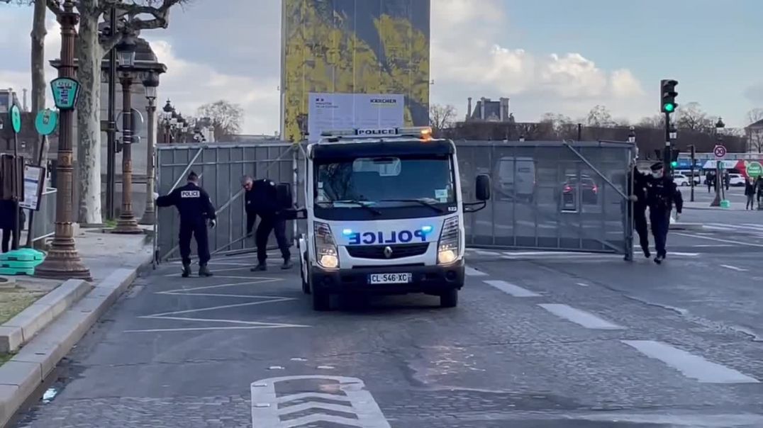 French blue pigs fencing the Avenue of Champs Elysees in Paris against convoy of freedom.