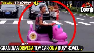 WOMAN DRIVES A TOY CAR ON A BUSY ROAD.. (CHINA)