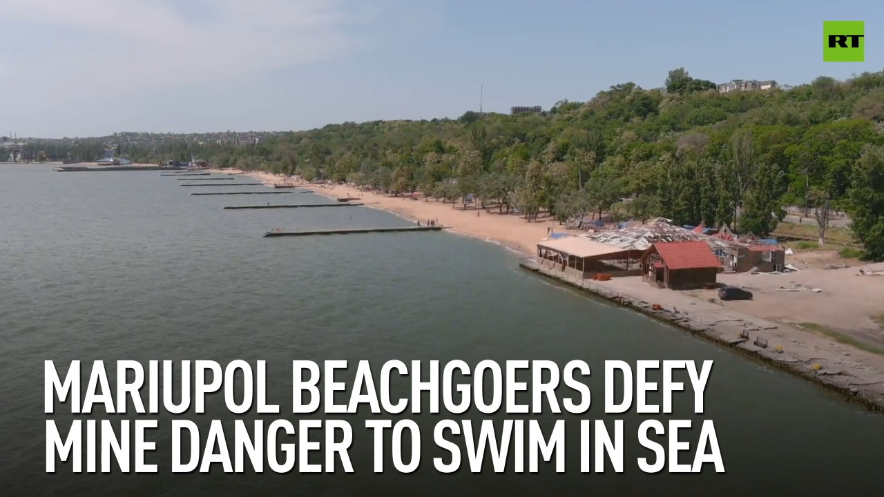 Mariupol beachgoers defy mine danger to swim in sea