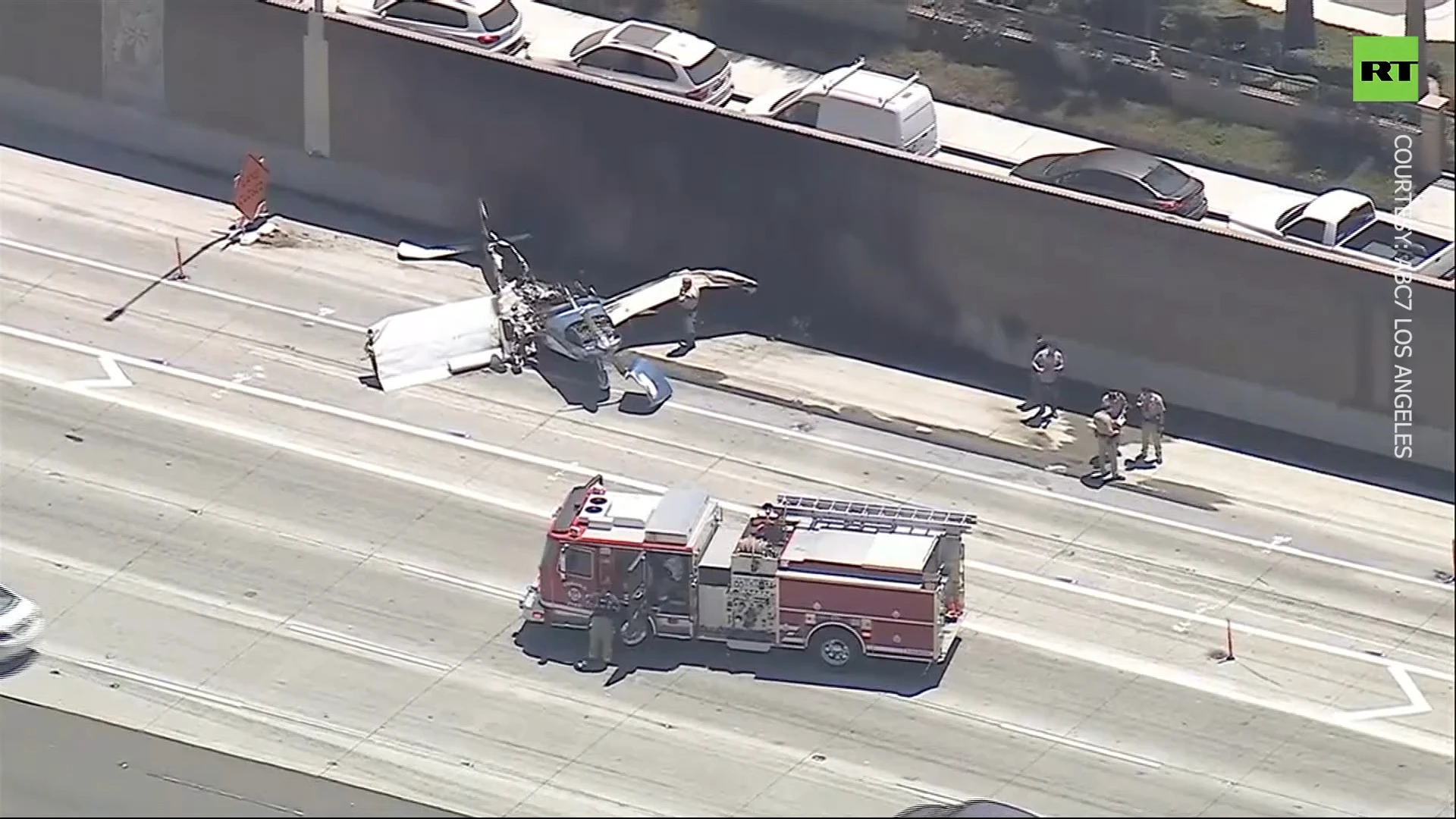 Plane crash lands on California freeway