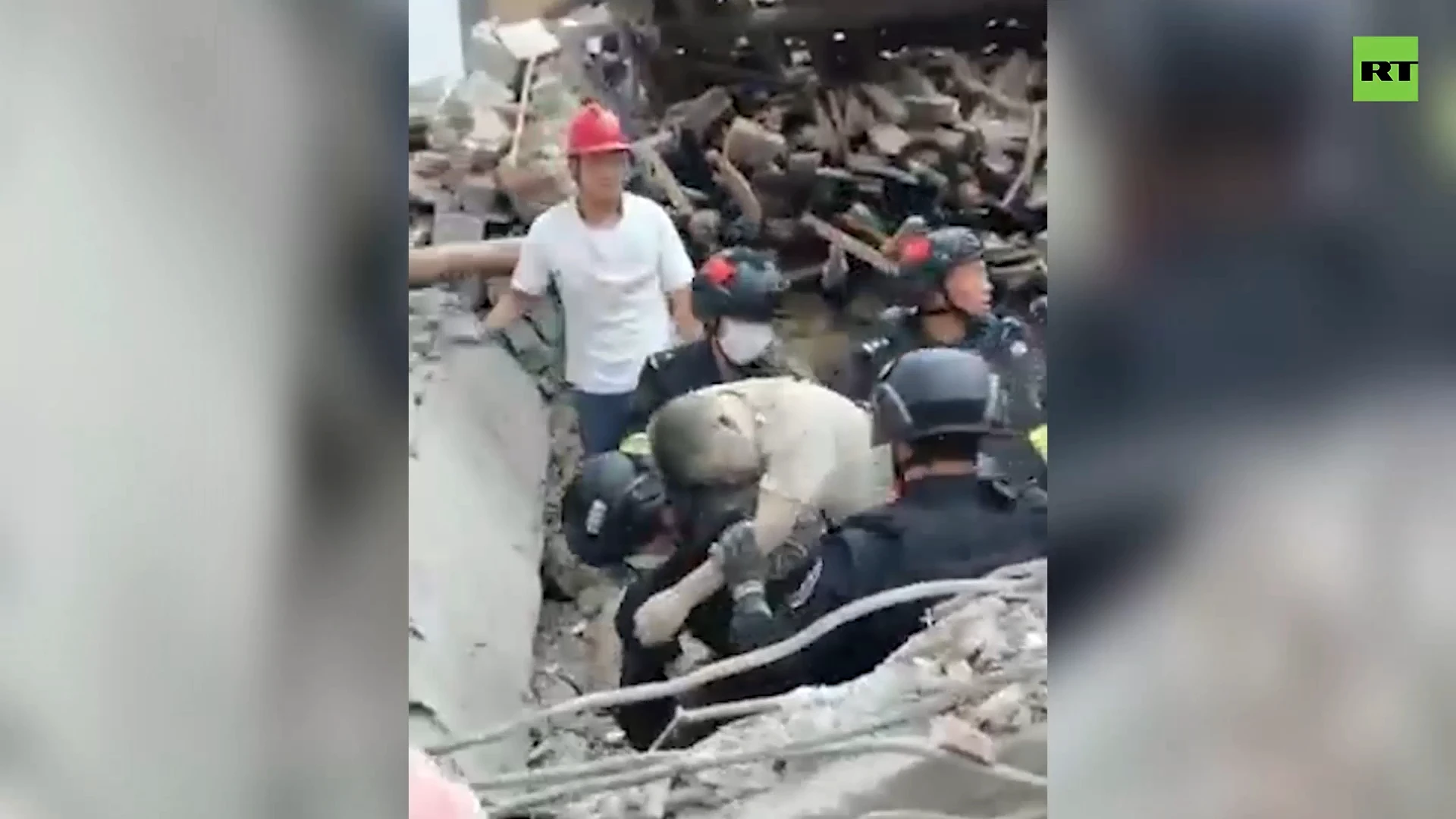 Police dig through earthquake debris with bare hands to rescue trapped man