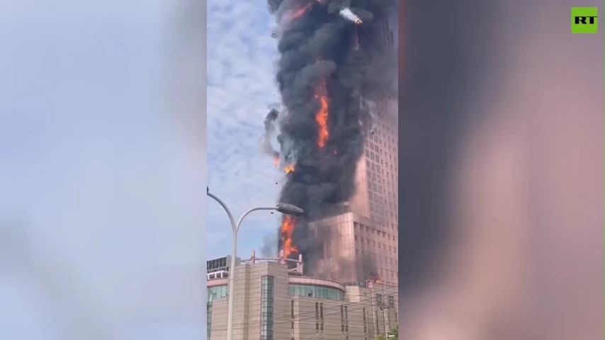 Huge fire engulfs office tower in China