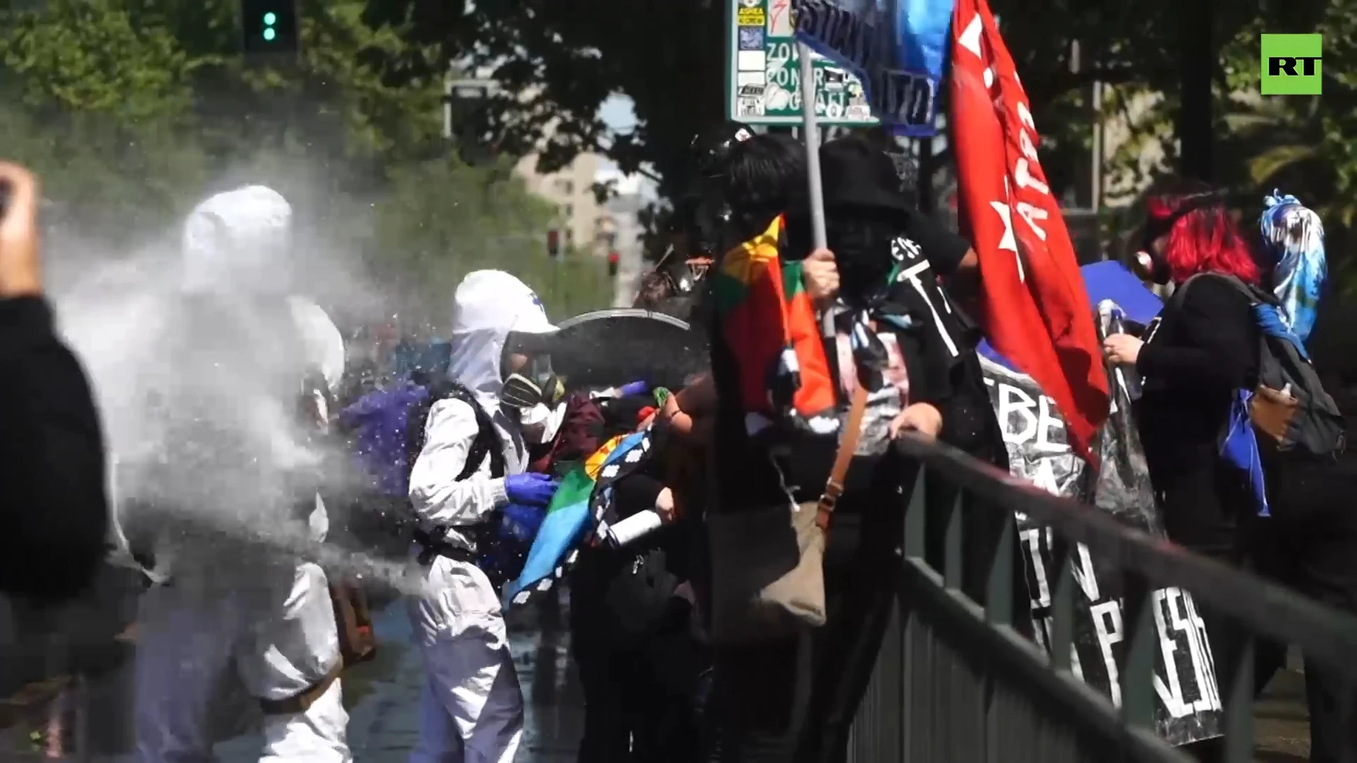 Indigenous Chileans soaked by water cannons at Columbus Day march