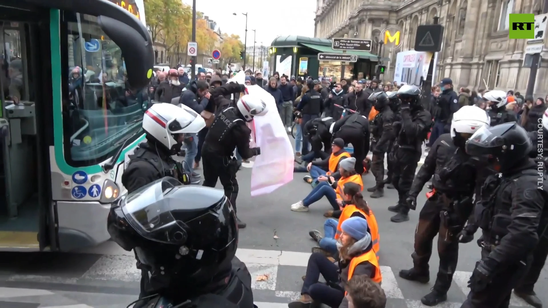 Police confront environmental activists blocking street in Paris