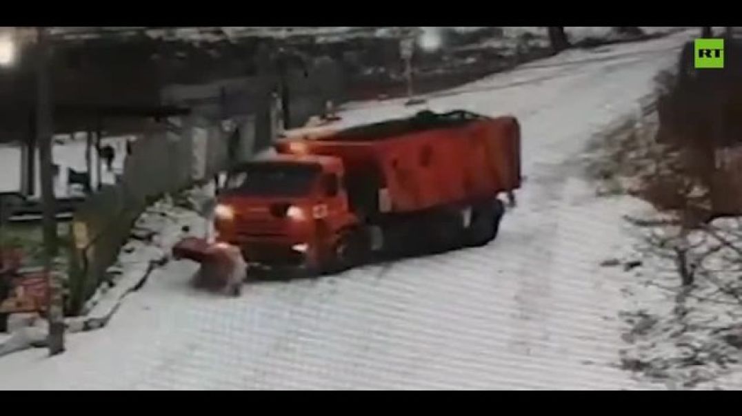 Trucks drift down the road attempting to clear snow