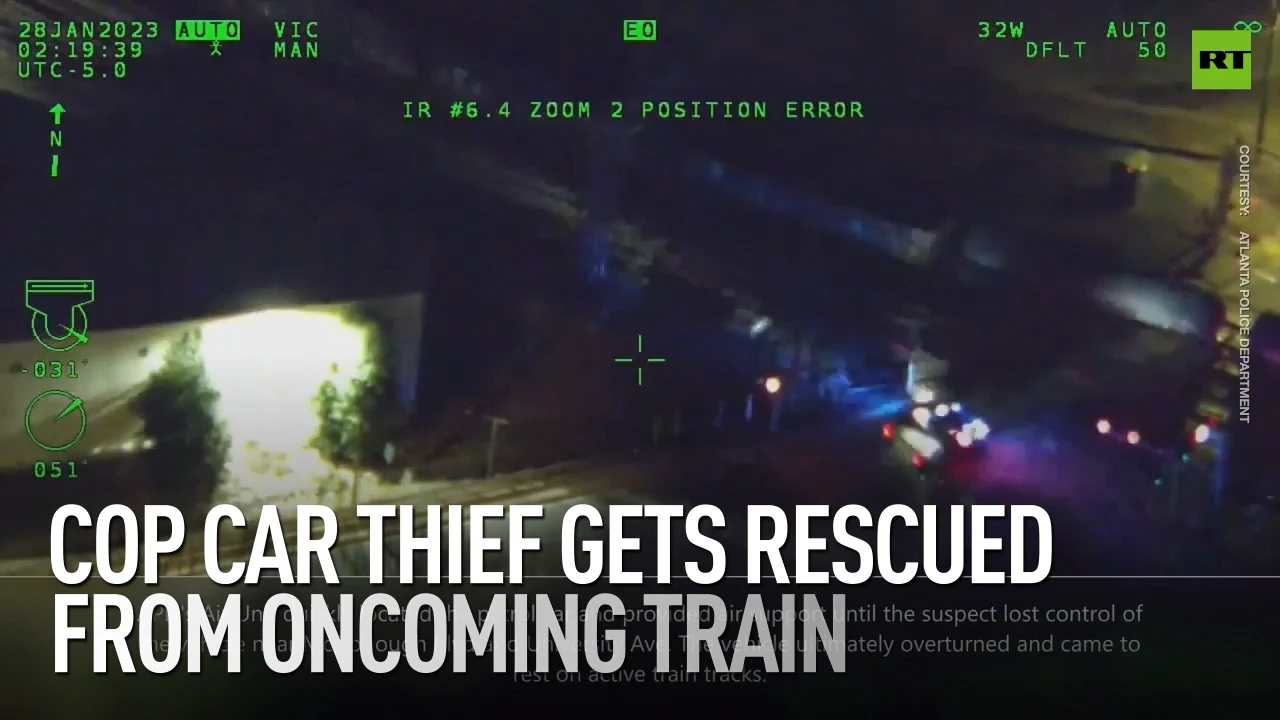 Cop car thief gets rescued from oncoming train