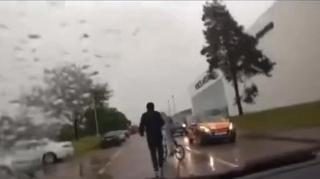 Aggressive young men block the road and are rude to driver so he turns around and splashes them with