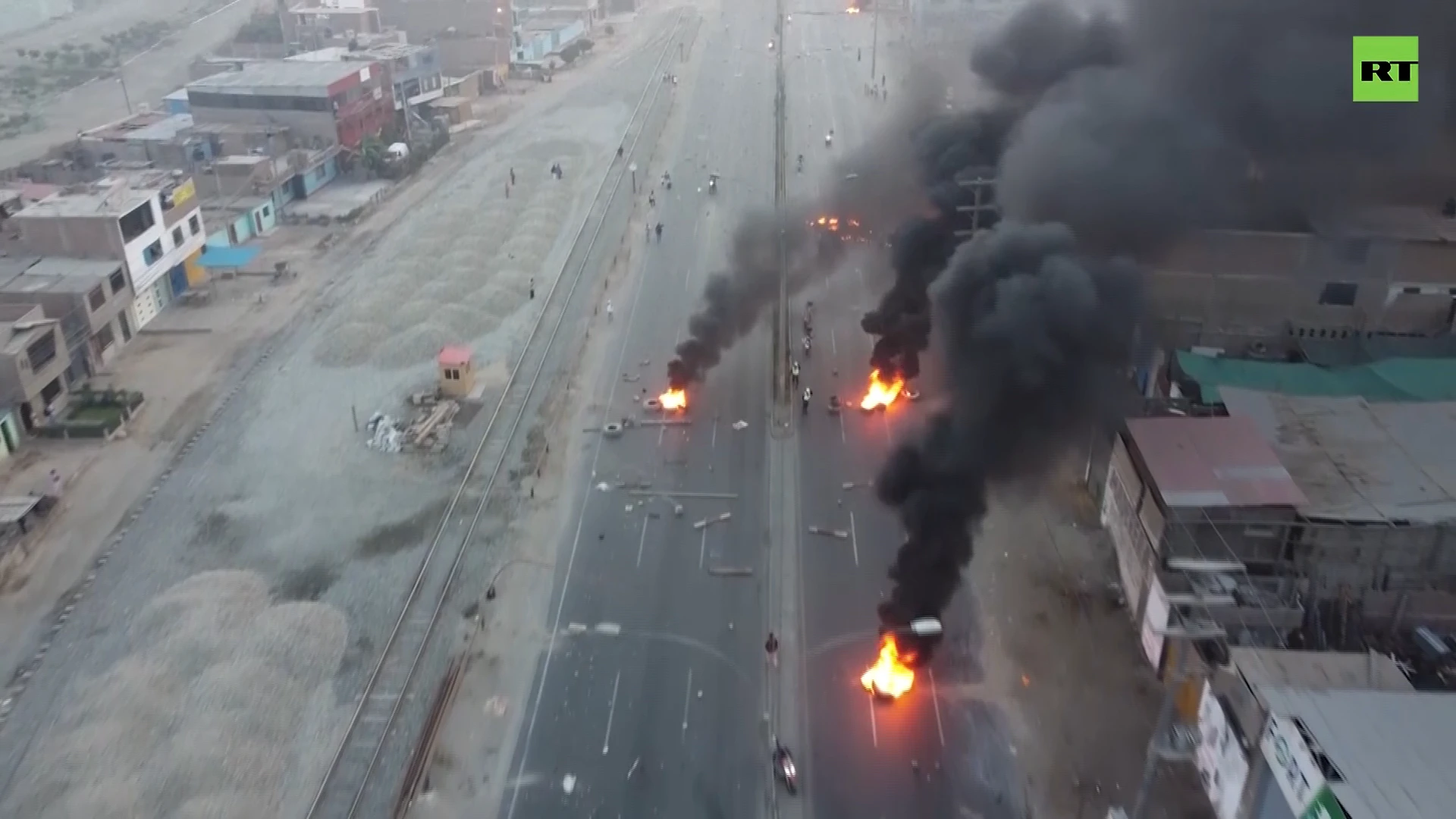 Protesters set fires to block major highway in Lima