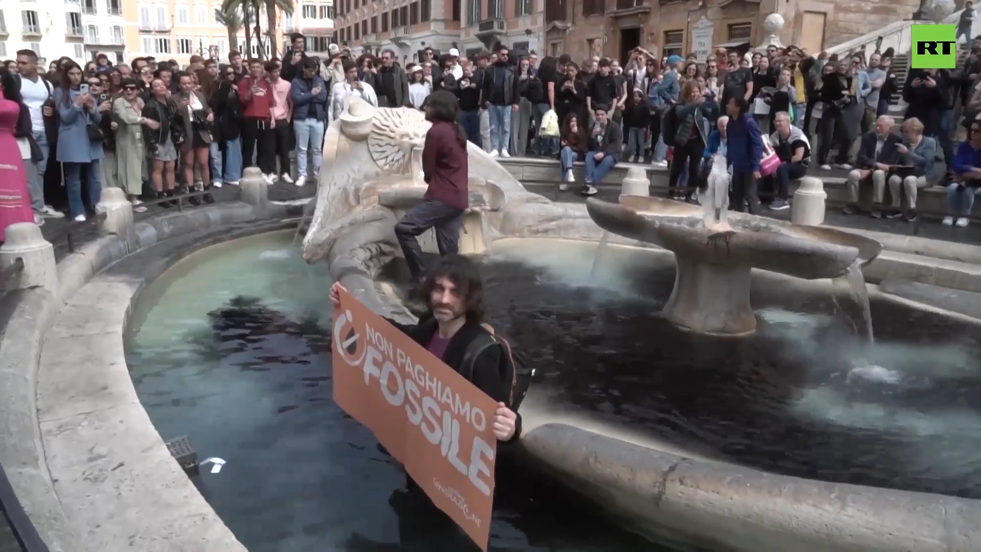 Rome's iconic fountain dyed black by climate activists