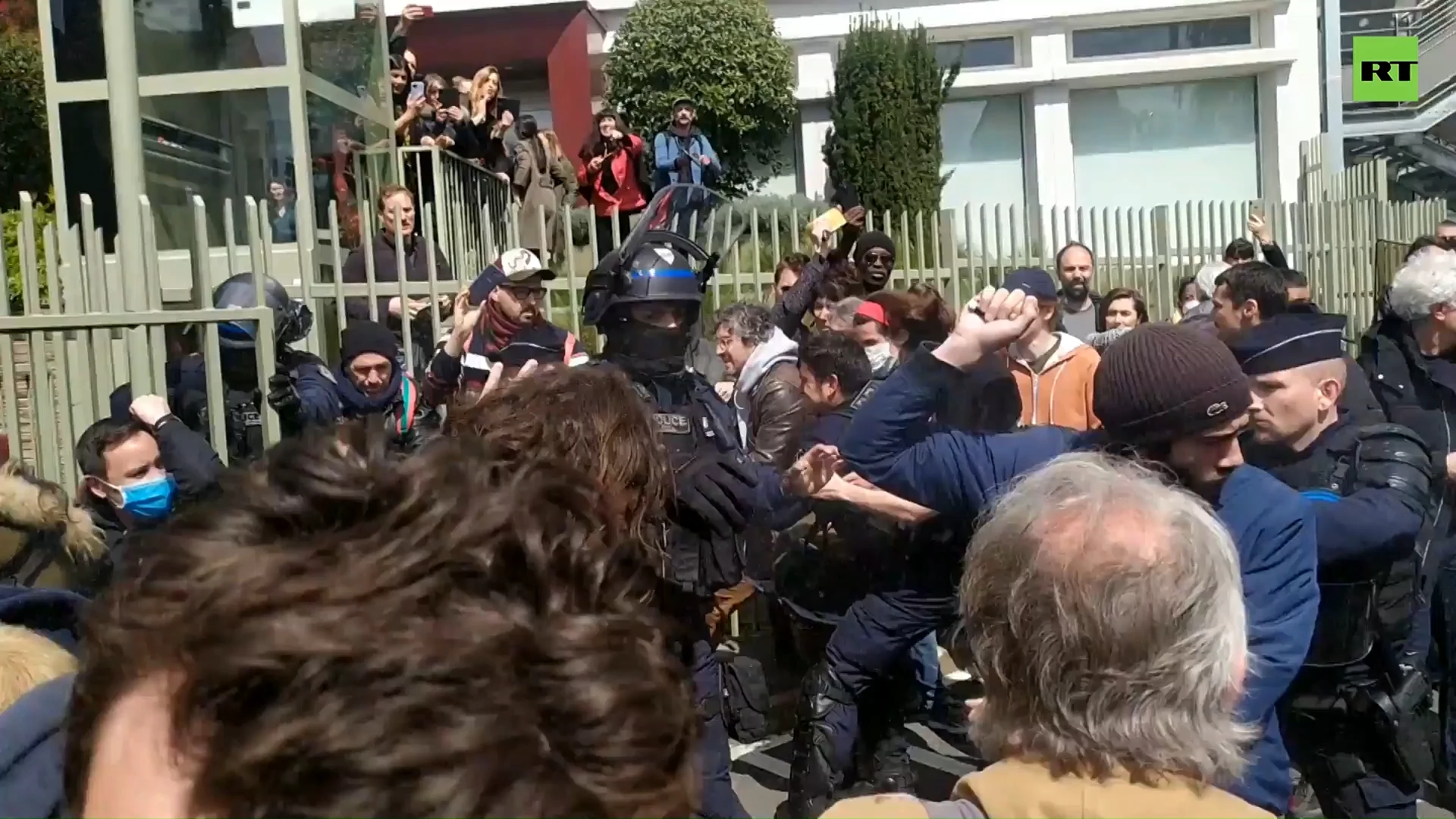 Protesters clash with police as health minister visits Paris suburb