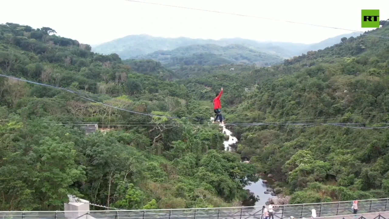 Chinese athletes walk tightrope over rainforest