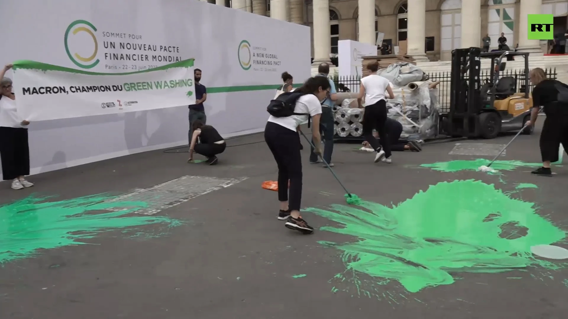 Eco-activists splash green paint in protest against Paris 'Greenwashing Summit'