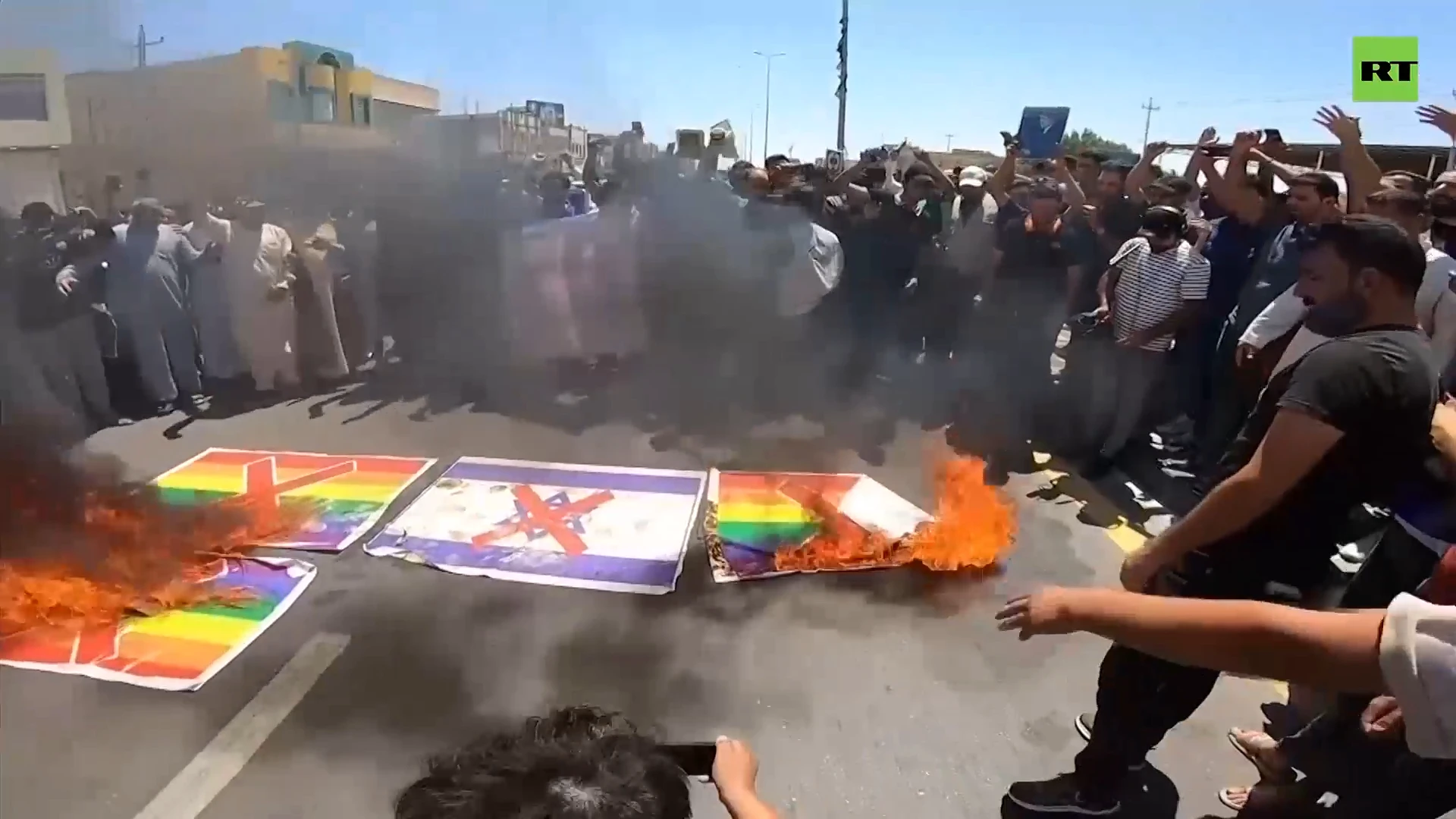 Iraqi Muslims set fire to LGBT flag in response to Quran burning in Sweden