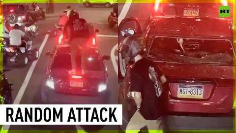 Police search for biker after smashing car window with children inside