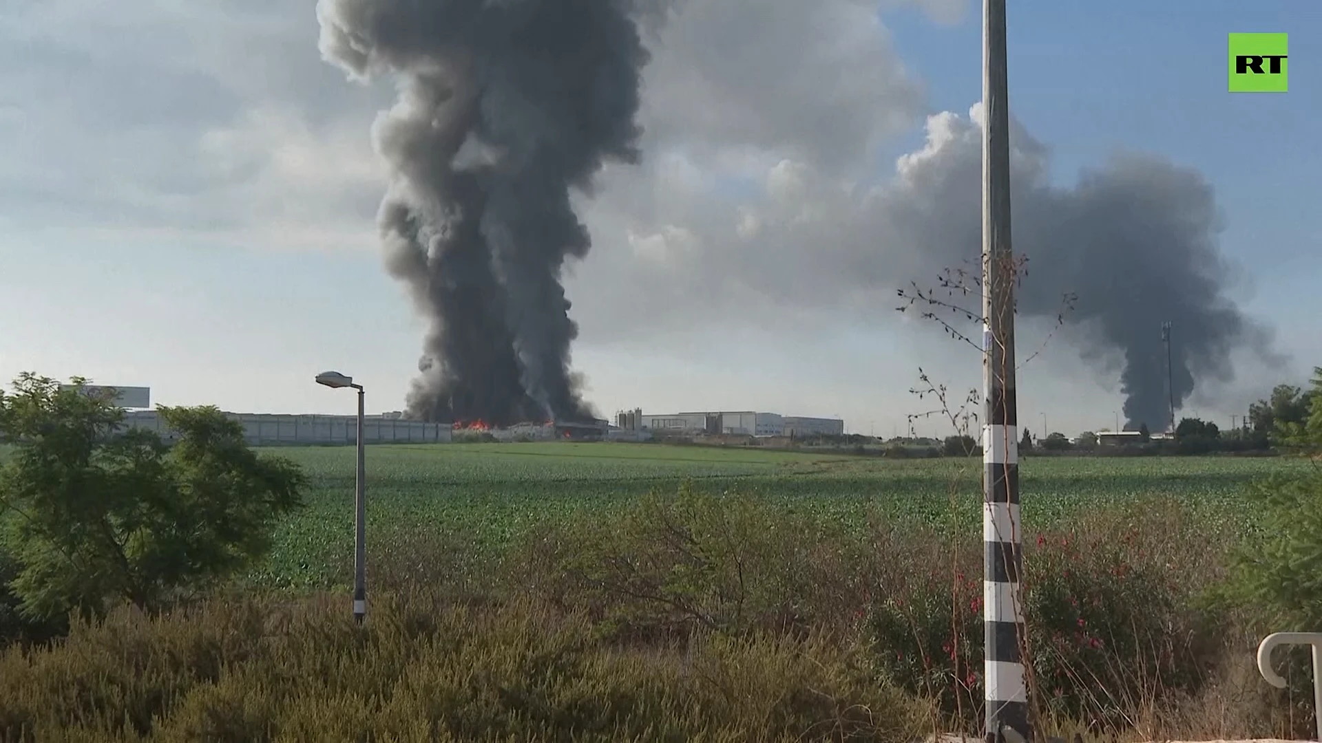 Clouds of smoke rise after rockets from Gaza hit buildings in Rehovot, Israel