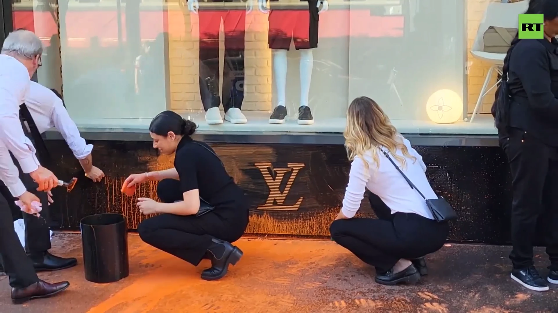 Louis Vuitton shop painted orange by eco-activists