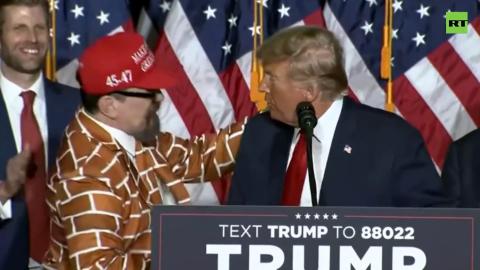 Trump invites man dressed as a wall up on stage during Iowa caucus victory speech