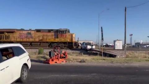 Train vs Pickup Truck towing a trailer - Look what it does to both of them
