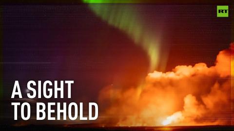 Northern lights illuminate erupting Iceland volcano