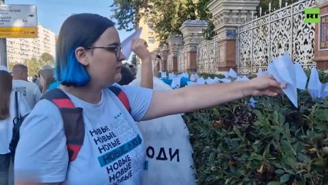 People lay paper planes at French embassy in Moscow