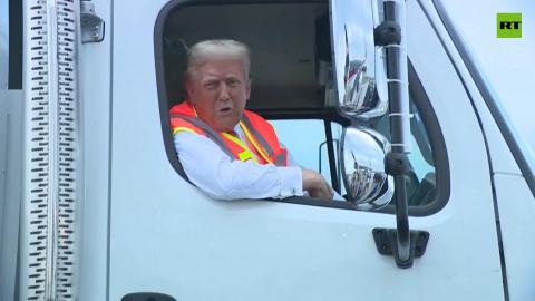 Trump talks to press from a garbage truck