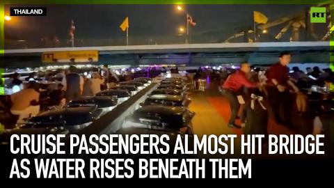 Cruise passengers almost hit bridge as water rises beneath them