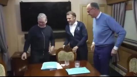 MACRON, STARMER and MERZ caught hiding WHITE BAG on table